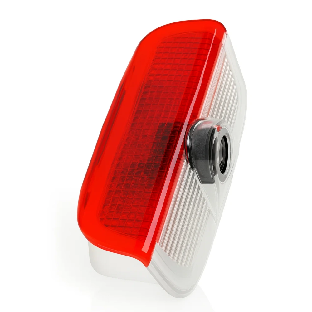 Close-up van de projectorlamp, waarop het rode glas en de lens te zien zijn.